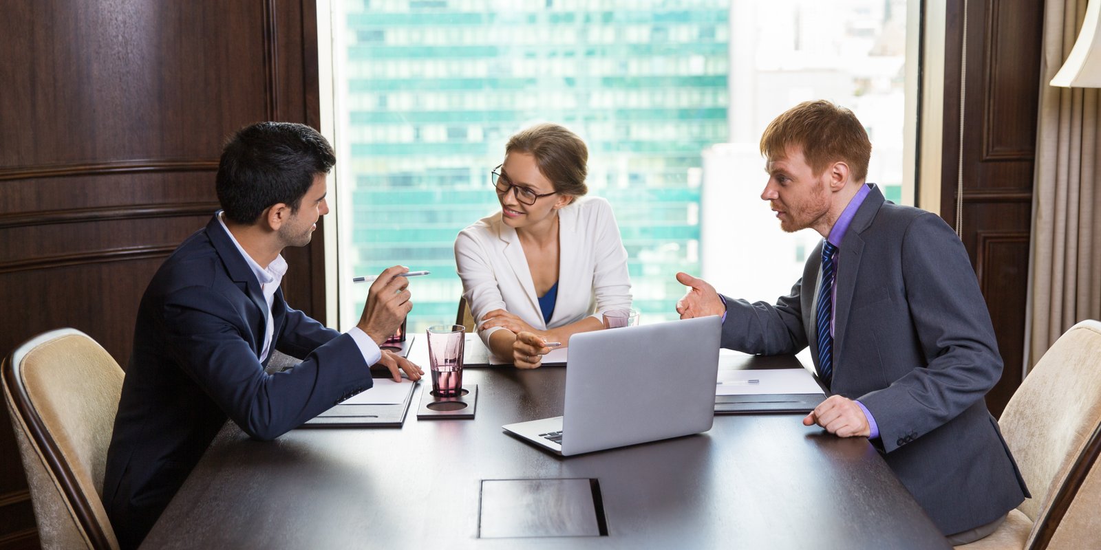 Business professionals reviewing documents in a boardroom setting