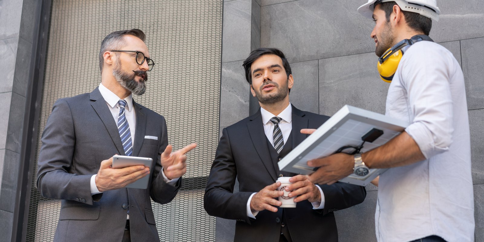 Construction litigation attorney reviewing blueprints and contract documents