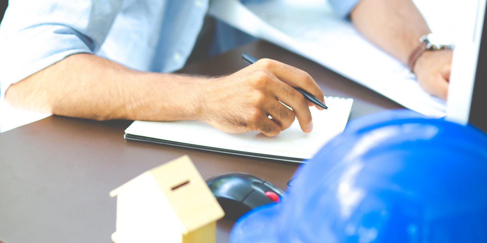 Construction lien attorney reviewing documents with contractor