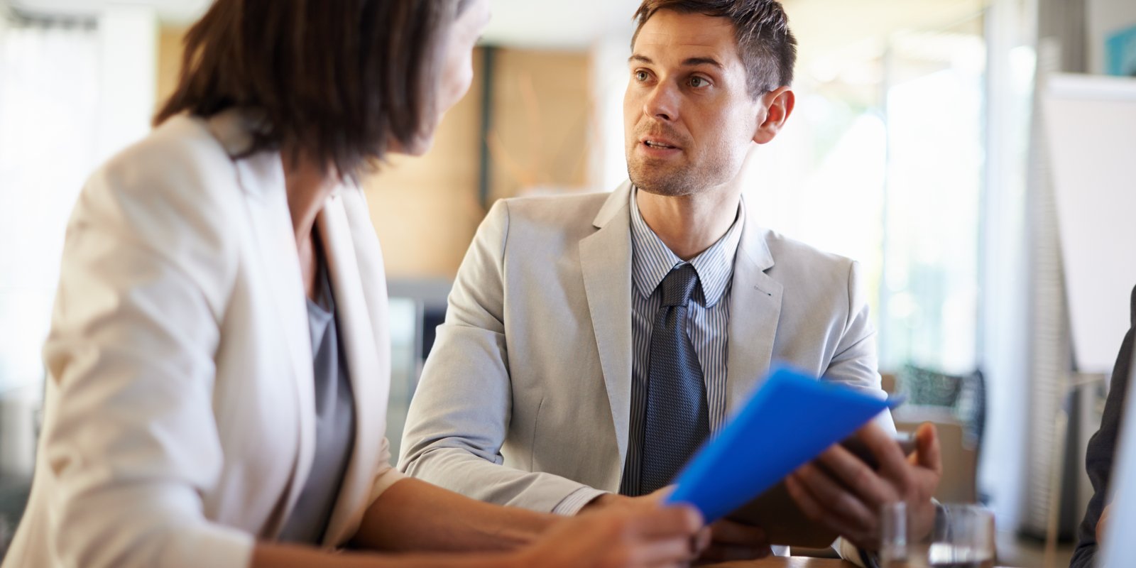 Business professionals discussing employment contract and legal documents